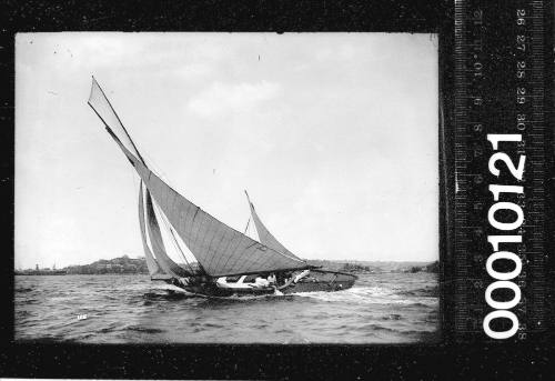 Portside view of two yachts leaning heavily on Sydney Harbour