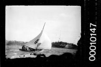 16-foot skiff sailing past Garden Island, Sydney Harbour