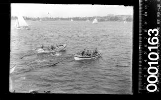 Two surf life rescue row boats racing on Sydney Harbour