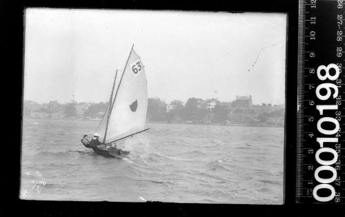 16-foot skiff with a shield emblem and the number '63' on the mainsail, Sydney Harbour