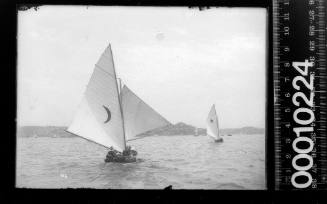 16-foot skiff marked with a crescent moon emblem, sailing near Shark Island's pile lighthouse, Sydney Harbour