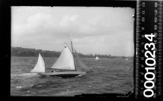Gaff rigged yawl yacht with the number '28' on the mainsail