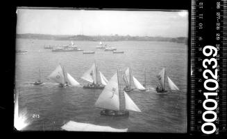 6-footers being towed to the start of a race, Sydney Harbour with a 16-footer in the foreground