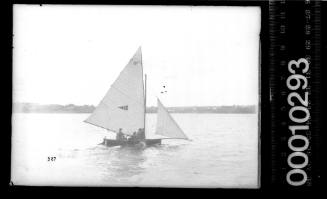 16-foot skiff with an emblem of a circle and cross within a dark triangle, Sydney Harbour