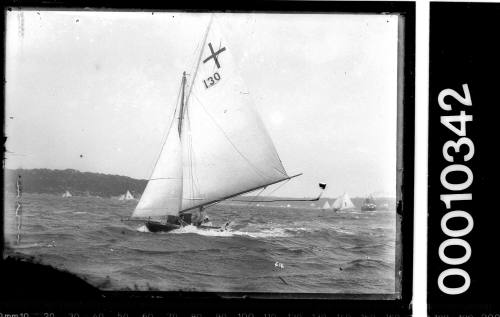 Small centreboard yacht with the number '130' and a cross emblem displayed on the mainsail, Sydney Harbour