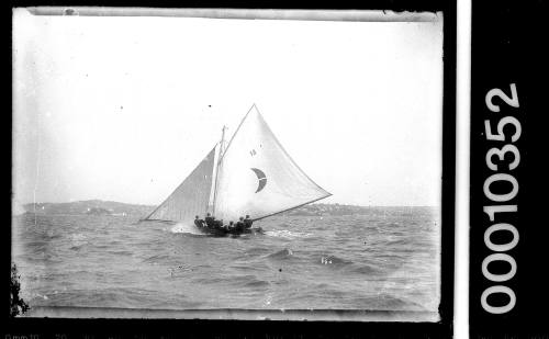 18-footer with a crescent-shaped emblem cut by a white stripe, Sydney Harbour