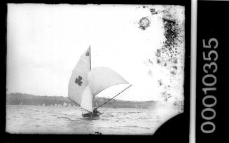 12-foot skiff with a shamrock emblem and the text 'L 10 ' on the mainsail, Sydney Harbour