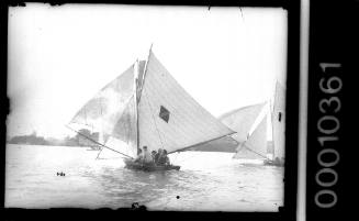 14-footer on Sydney Harbour featuring a diamond emblem with a central horizontal stripe