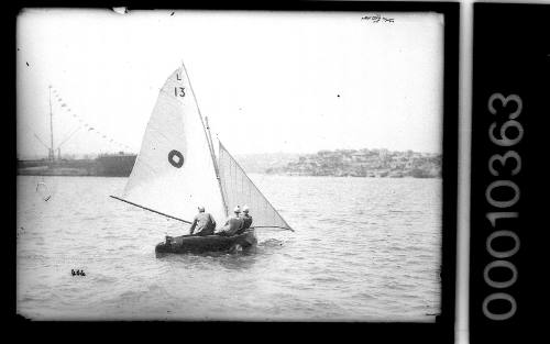 Lane Cove 12-foot skiff with an emblem of a diamond within a circle and the text 'L 13' on the mainsail, Sydney Harbour