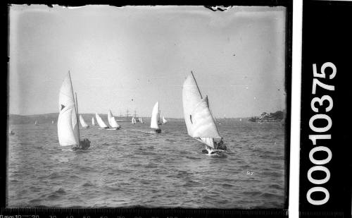 16-foot skiffs on Sydney Harbour with a three-masted ship in the background