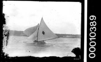 14-footer on Sydney Harbour displaying a diamond emblem intersected by a horizontal stripe