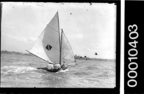 16-foot skiff on Sydney Harbour displaying an emblem consisting of a diamond dissected by a vertical stripe