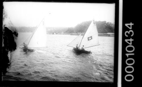 Two 16-foot skiffs racing on Middle Harbour, Sydney