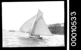 Sailing vessel with the number '18' displayed on the mainsail, Clark Island, Sydney Harbour