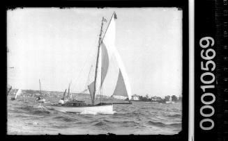 Sailing vessel on Sydney Harbour flying a dark pennant with a light-coloured cross