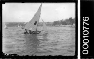 Unfocused image of a 12-foot skiff sailing near the shore on Sydney Harbour