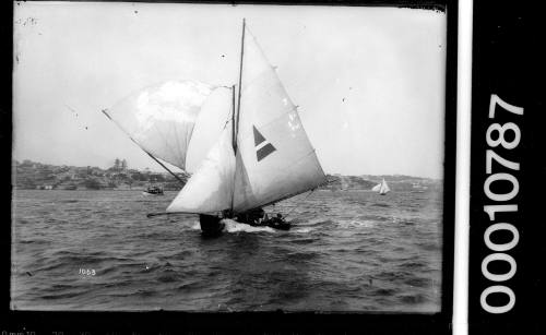 12-foot skiff under full sail on Sydney Harbour