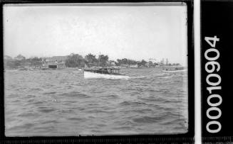 Wooden cruiser passing the St George Motor Boat Club