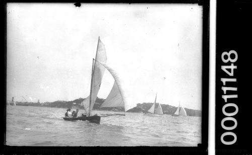 16-foot skiff on Sydney Harbour 2 larger yachts in distance.