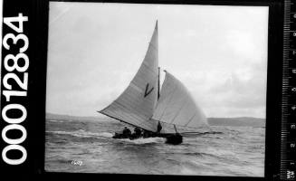 Starboard view of a yacht under sail with spinnaker and the letter 'V' printed on the mainsail, Sydney Harbour