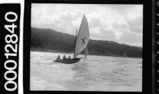 16-foot skiff with a large 'X' symbol on the mainsail, sailing on Sydney Harbour