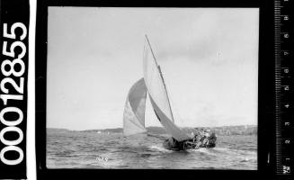 Sailing vessel on Sydney Harbour with crew seated against the bulkhead