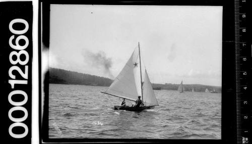 6-foot skiff yacht with a star emblem on the mainsail, Sydney Harbour