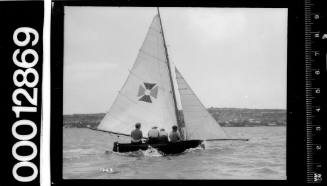 Small yacht under sail with a maltese cross emblem on the mainsail, Sydney Harbour