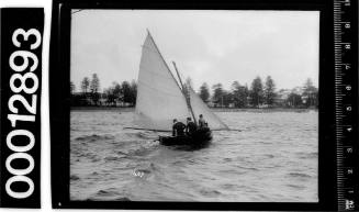 6-foot skiff yacht with three crew onboard, Manly, Sydney