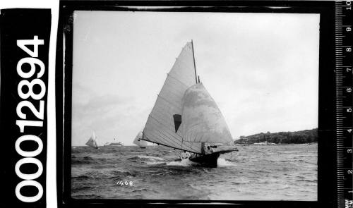 Single masted yacht with a cone shaped emblem on the mainsail sailing near shoreline, (possibly Dobroyd Point) Sydney Harbour