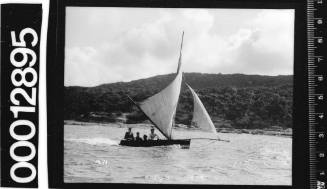 Single masted yacht with four crew members visible, Sydney Harbour