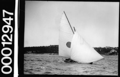 Yacht with a large dark circle displayed on the mainsail, Sydney Harbour