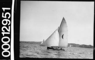 Skiff with a crescent moon emblem on Sydney Harbour