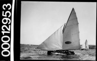 Yacht displaying an oval emblem with the letter 'V' in the centre, Sydney Harbour