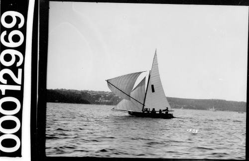 Yacht with dark rectangle emblem on the mainsail, Sydney Harbour