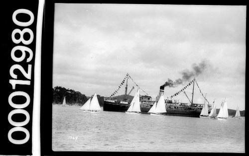 Amateur class yachts sailing in front of a spectator ferry