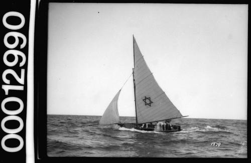 Port view of a yacht under sail on Sydney Harbour with a Star of David emblem on the mainsail