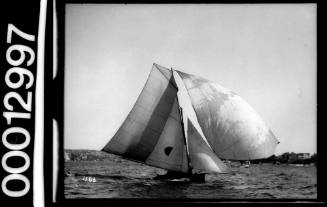 Yacht with a half circle emblem on the mainsail, Sydney Harbour