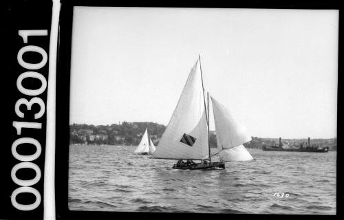 18-foot skiff with striped rectangle sail insignia sailing on Sydney Harbour off Eastern Suburbs