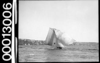 Yacht with a half circle emblem on the mainsail, Sydney Harbour