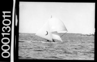 Skiff with a crescent moon emblem on the mainsail, Sydney Harbour