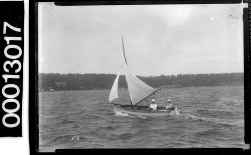 Small yacht under sail with two people onboard, Sydney Harbour