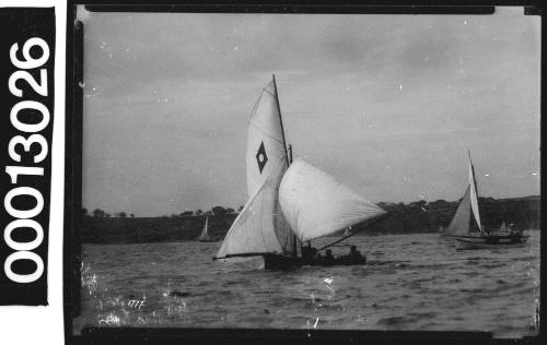 Yacht with an emblem of a white dot within a dark diamond, Sydney Harbour