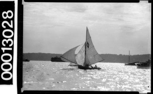 Yacht with an emblem of a white dot within a dark diamond, Sydney Harbour