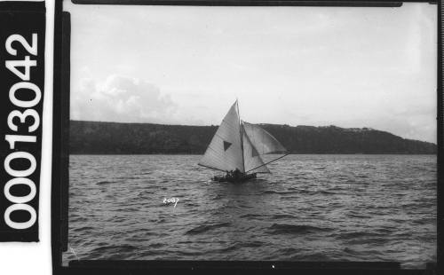 Yacht with a dark triangle on the mainsail, Sydney Harbour