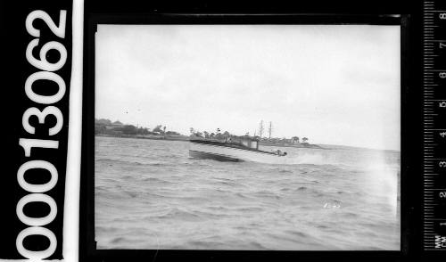 Portside view of speedboat motoring on Sydney Harbour