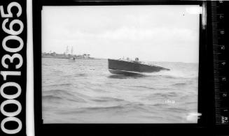 Portside view of a speedboat motoring on Sydney Harbour