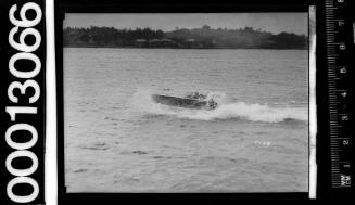 View of speedboat partly obscured by spray, on Sydney Harbour