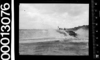 Stern view of a speedboat motoring on Sydney Harbour