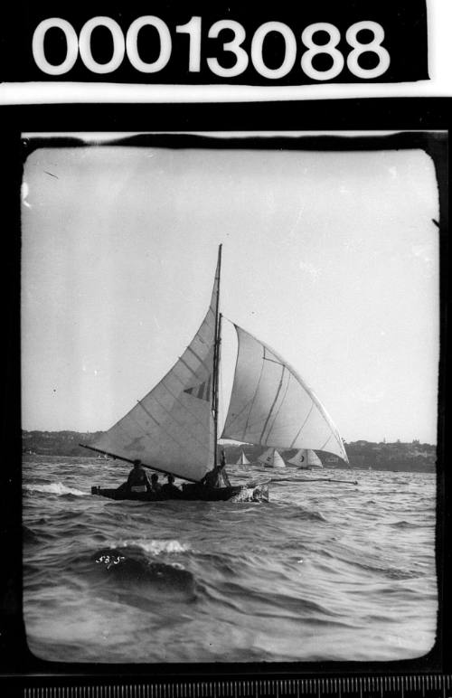 Yacht displaying an emblem on the mainsail of a triangle with vertical dark and light stripes, Sydney Harbour